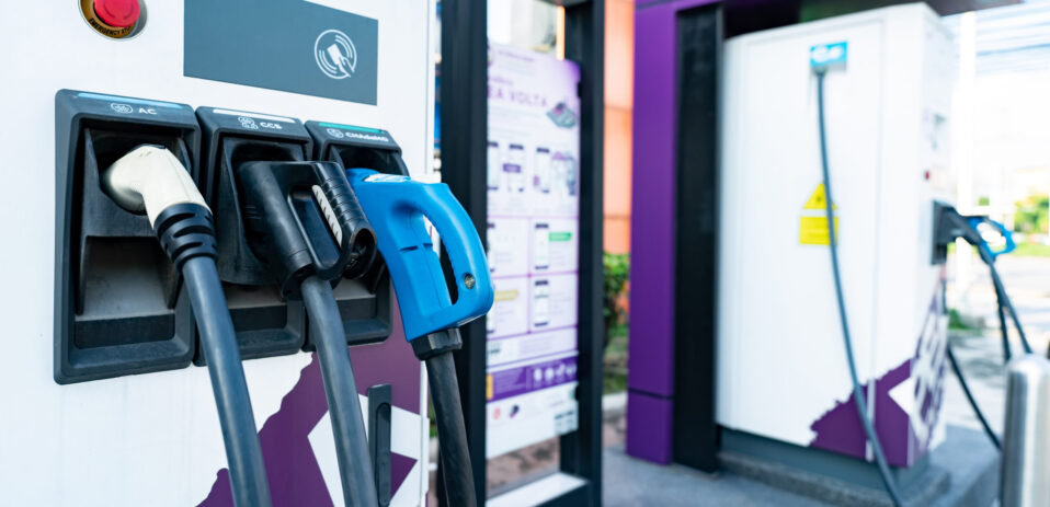 Electric car charging station. Electric vehicle charger. Charging point at outdoor car parking lot. Sustainable energy. Commercial EV charging point for charge EV battery. Carbon neutrality. Net zero.